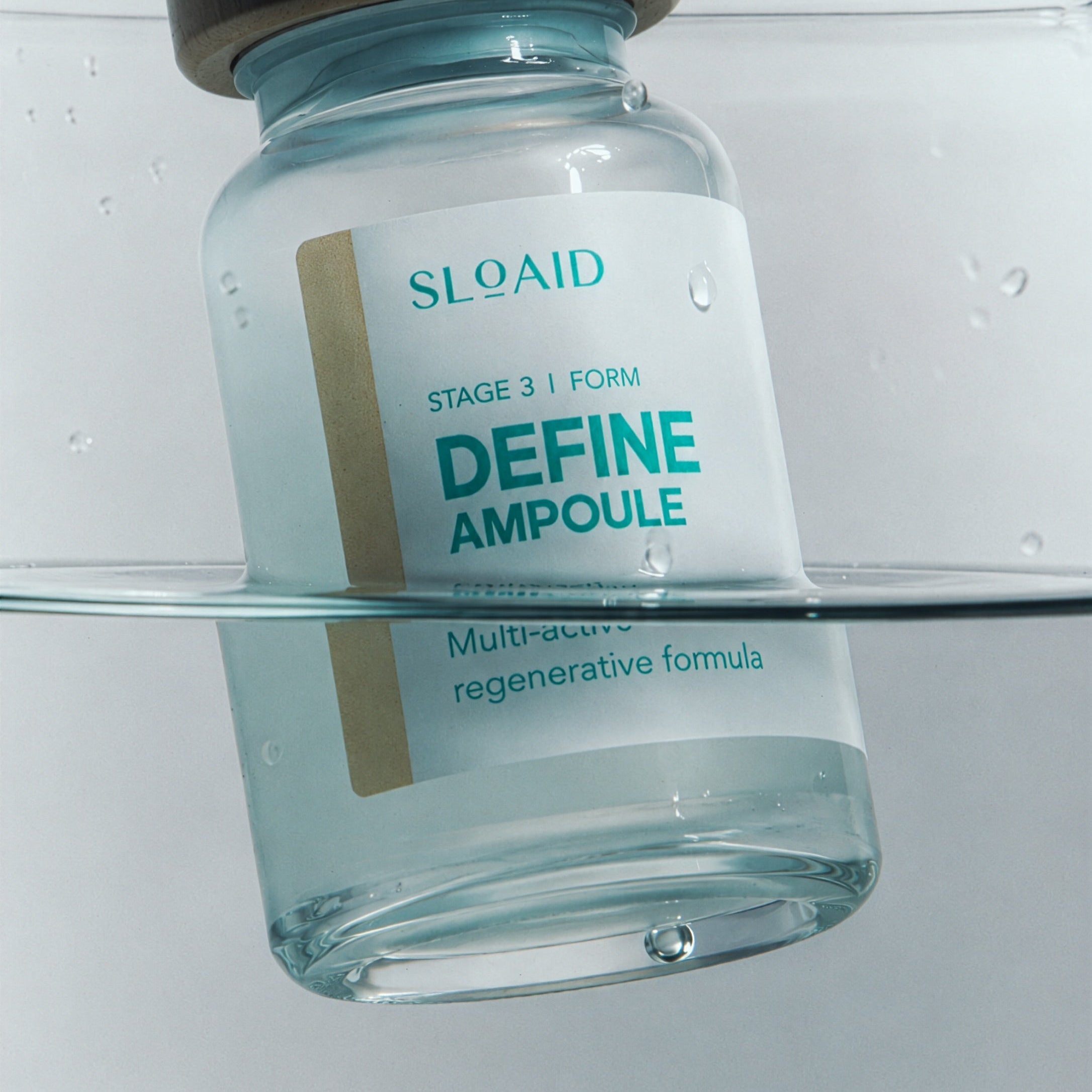 Close-up of the SLOAID Stage 3 Define Ampoule vial partially submerged in clear water