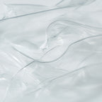 Close-up of transparent hydrogel mask sheets layered to highlight their smooth, ultra-thin texture.