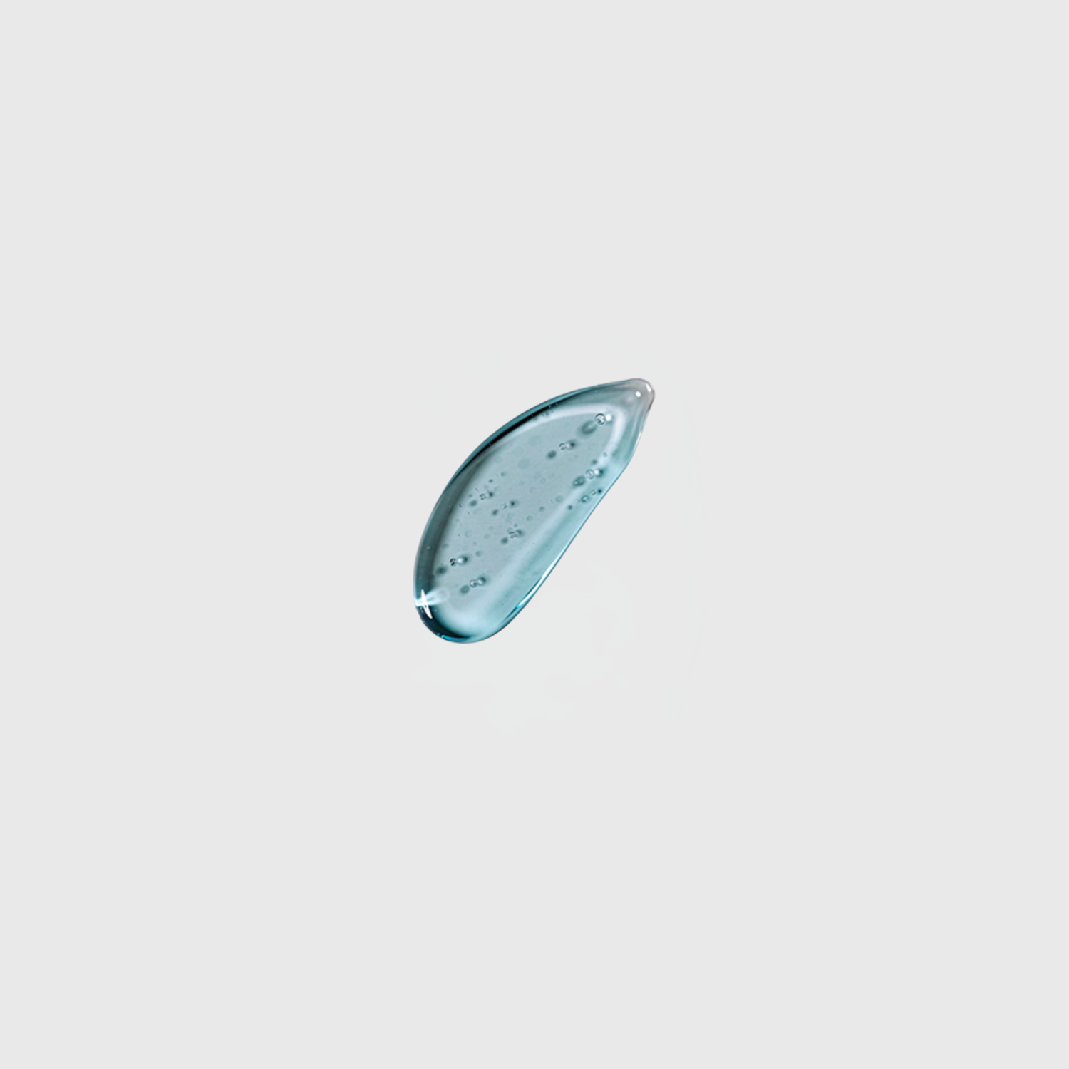 Blue gel droplet with tiny air bubbles on a light gray background